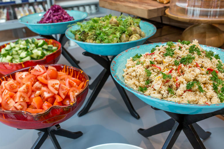 Photo of assorted salads in large coloured bowls