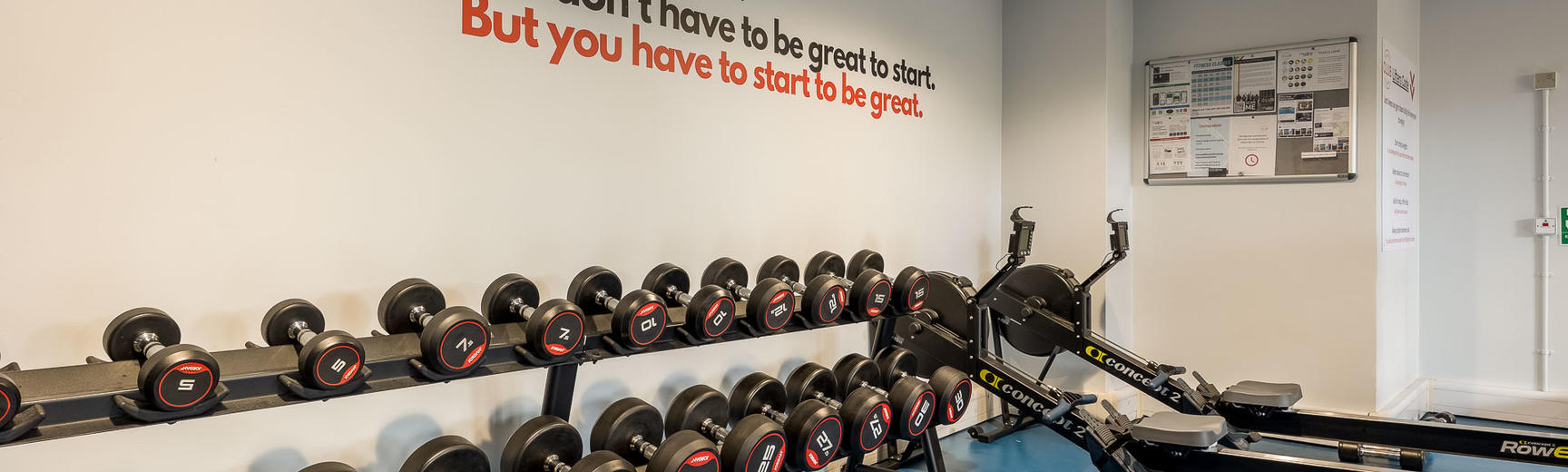 The University Club Gym, showing hand weights and a rowing machine