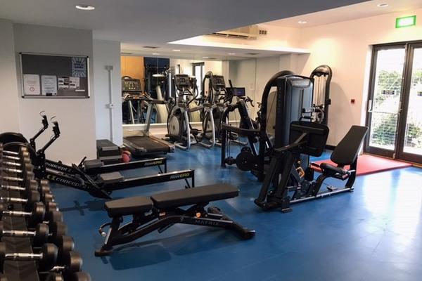 Photo of a gym with various cardio and resistance equipment