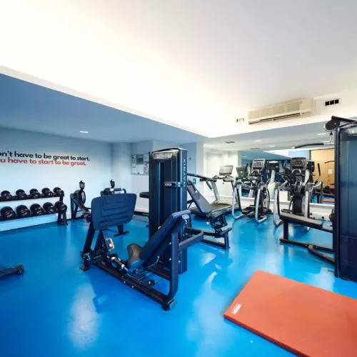 View into the University Club Gym showing the dumbell weights, weights machines and running machines