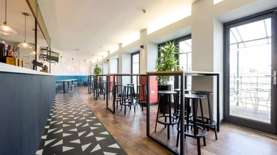 The Bar and Terrace laid out with high bar tables and stools