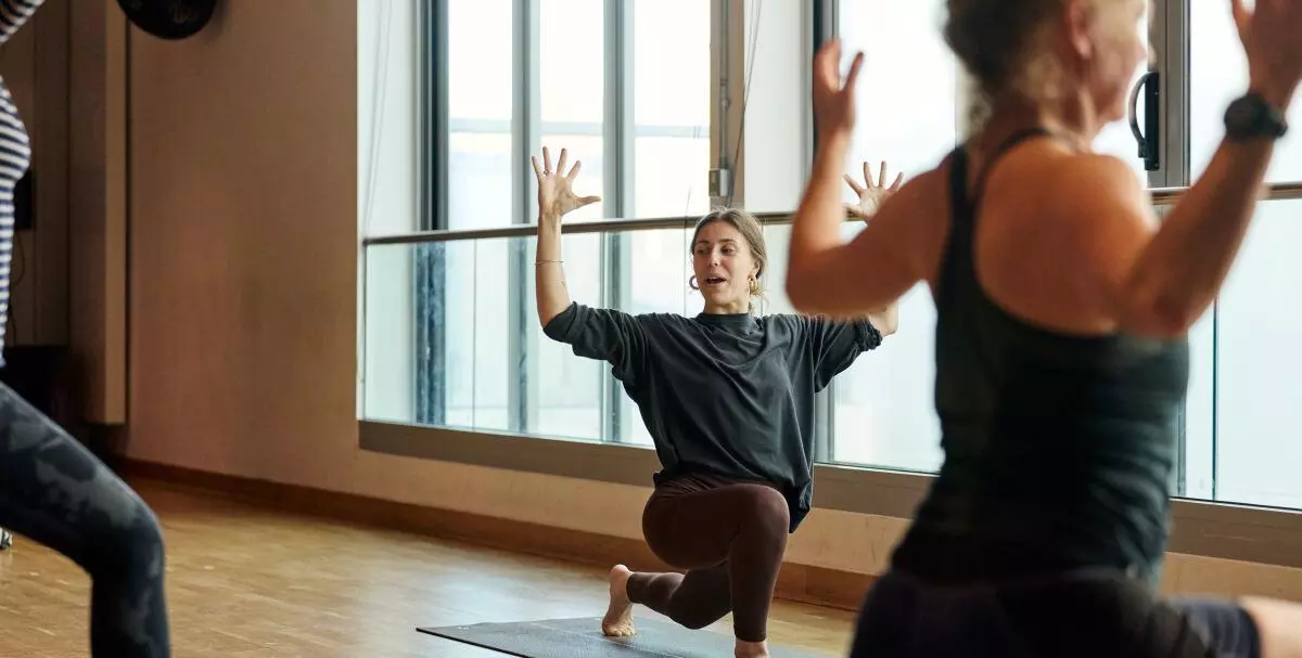 Three ladies lunging in a fitness class